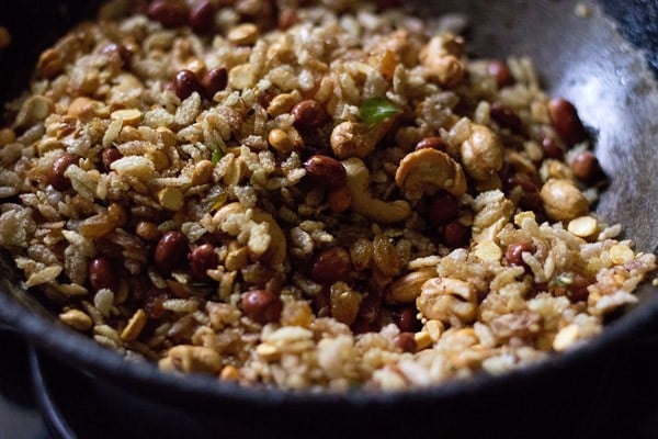 fried ingredients in pan to make poha chiwda recipe