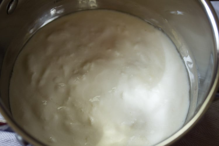 full-fat sour curd added in a pan. 