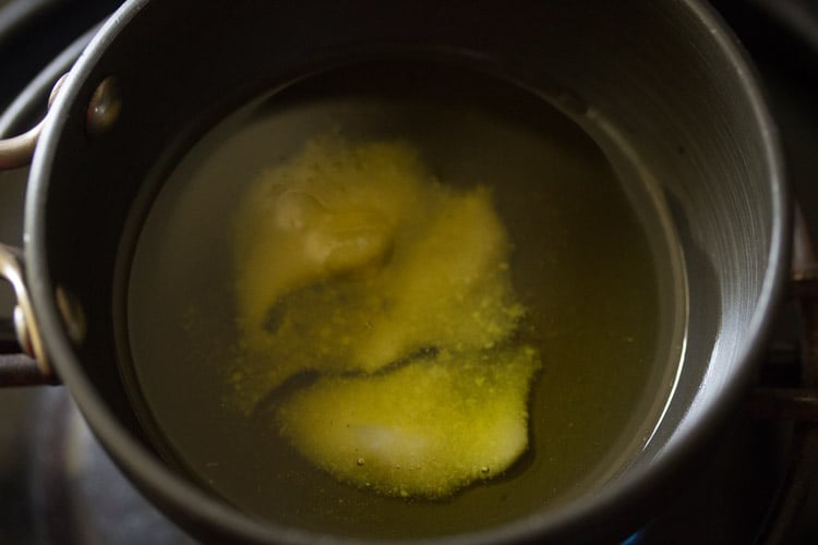 heating ghee in a small pan for making tempering. 
