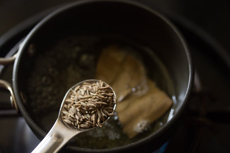 adding cumin seeds to the pan. 