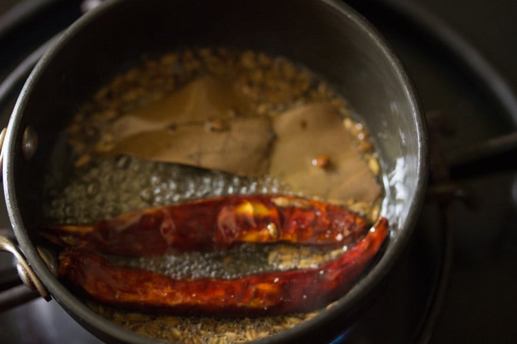 dried red chilies added to the pan. 