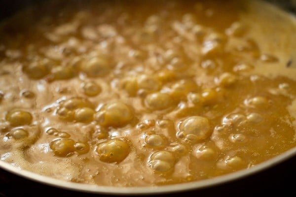 simmering rajma curry to thicken it with the smashed beans