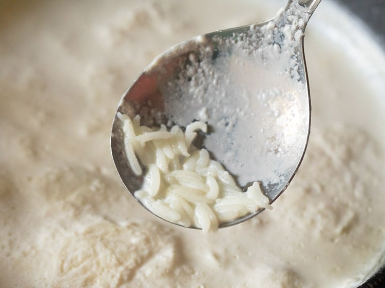 cooking the rice grains till 50% done or half-cooked.