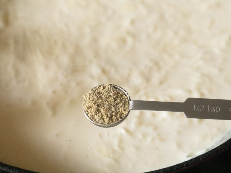 adding cardamom powder to the kheer.