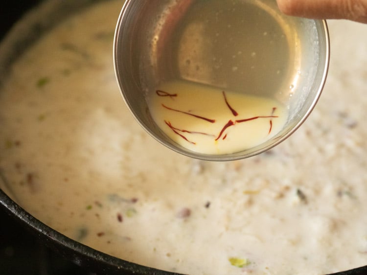 adding prepared saffron milk to the kheer. 