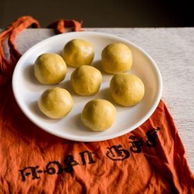 maladu served on a white plate kept on an orange colored cloth.