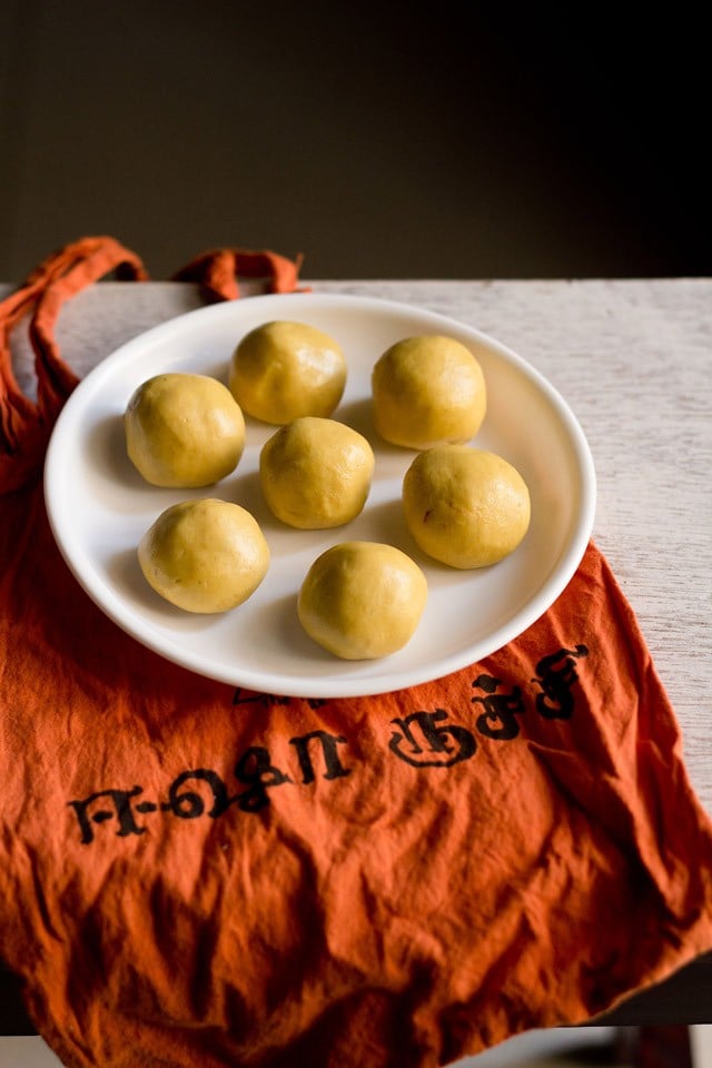 maladu served on a white plate kept on an orange colored cloth.
