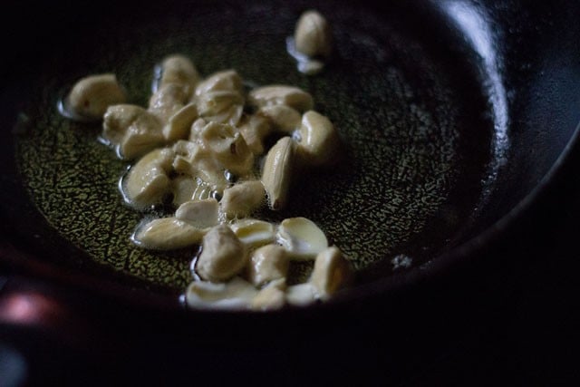 frying cashews in hot ghee. 