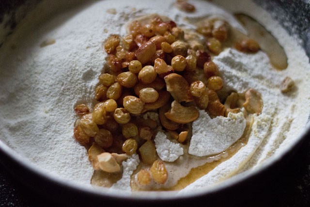 fried cashews and raisins added to the ground chana dal-sugar mixture. 