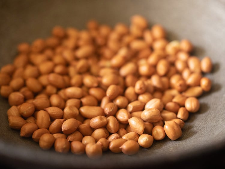 peanuts added in a frying pan for sabudana khichdi recipe.