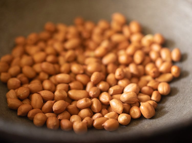 peanuts added in a frying pan for sabudana khichdi recipe. 