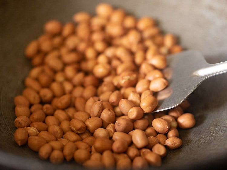 roasting peanuts in a frying pan for sabudana khichdi recipe. 