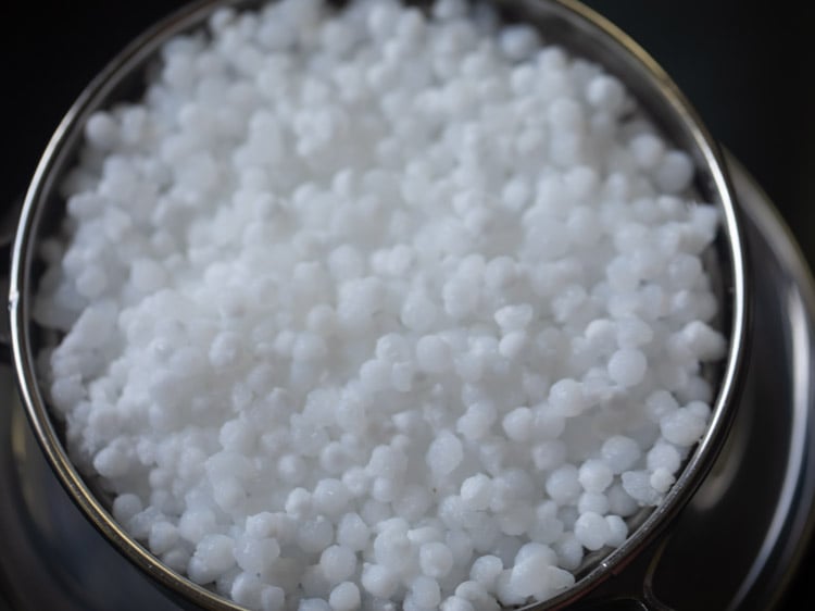 straining water from soaked sabudana for sabudana khichdi recipe.