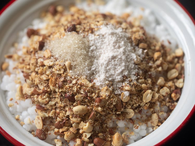 salt and sugar added to sabudana-peanut powder mixture for sabudana khichdi recipe.
