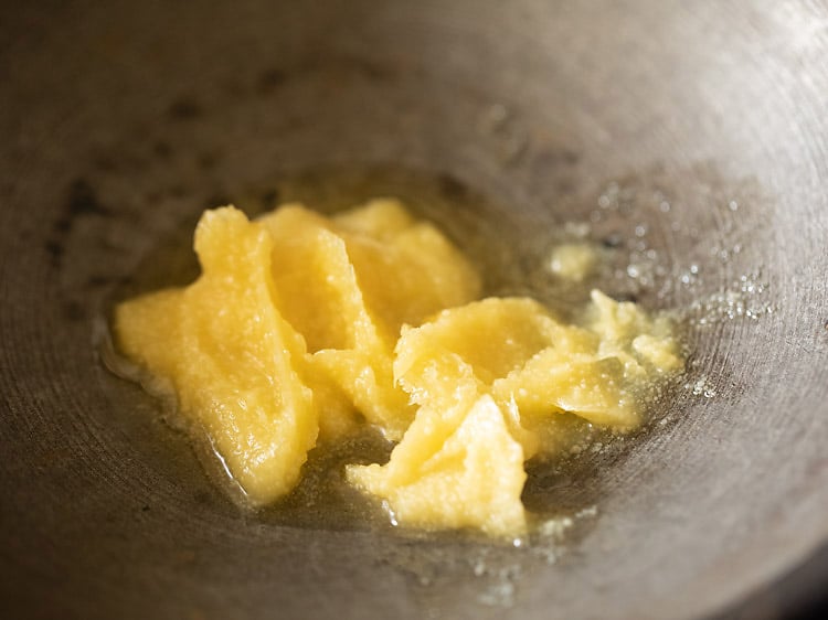 heating ghee in a pan.