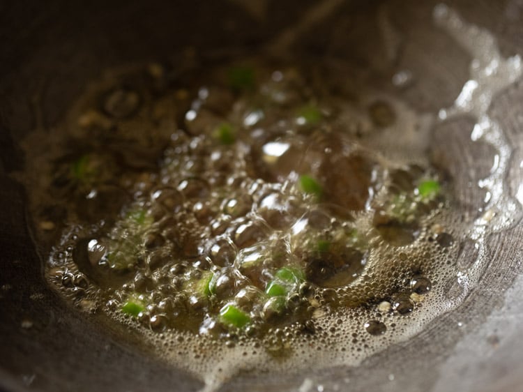 frying green chilli for a few seconds.