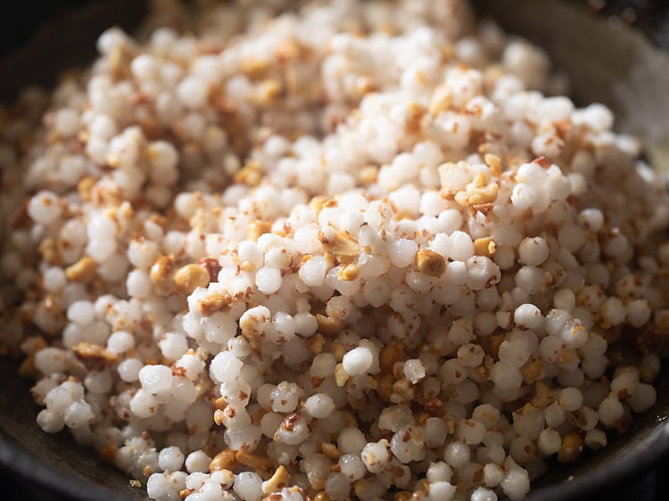 sabudana-peanut powder mixture added to pan. 