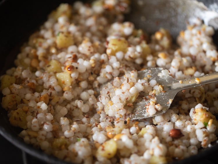 sautéing sabudana-potato mixture.