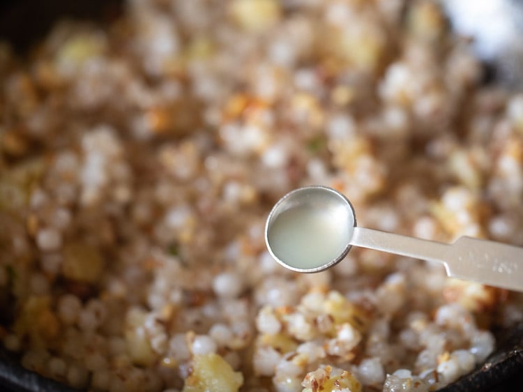 adding lemon juice to sabudana khichdi. 