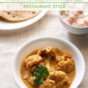 gobi masala garnished with coriander leaf and served in a bowl with a plate of chapattis kept on the left side and a small bowl of raita kept on the right side and text layovers.