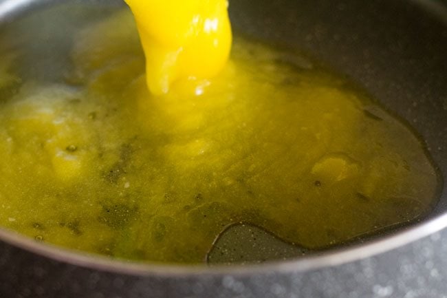 heating ghee in another heavy pan for frying cashews for atta halwa recipe. 