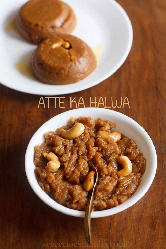 wheat halwa garnished with cashews and served in a white bowl with a spoon in it and text layovers. 