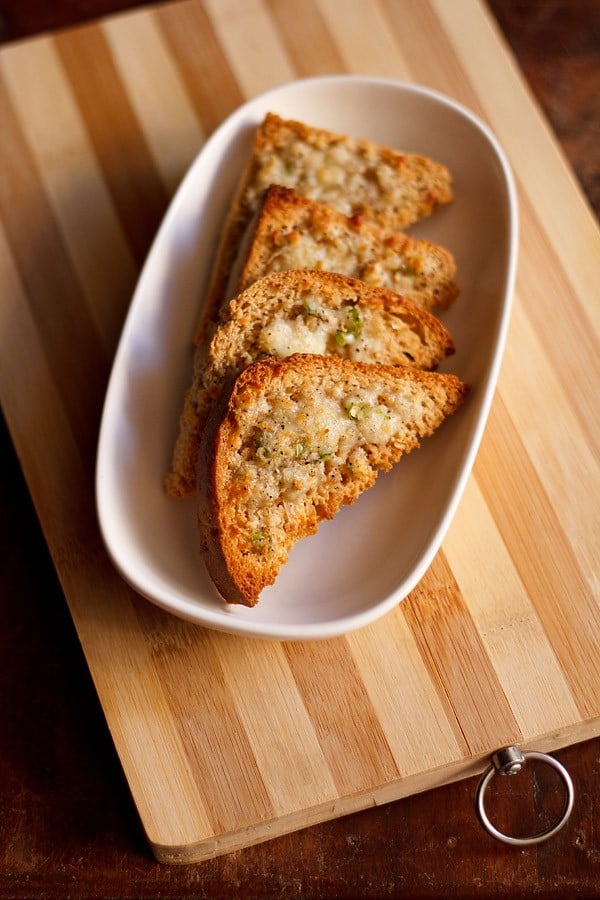 slices of cheese chilli toast on wooden board.