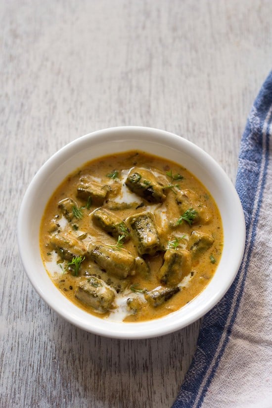 dahi bhindi served in a white bowl