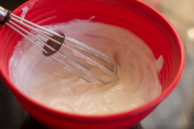 whisking curd in a bowl