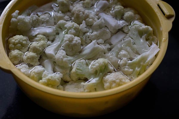 soaking gobi florets in hot water for making cauliflower masala. 