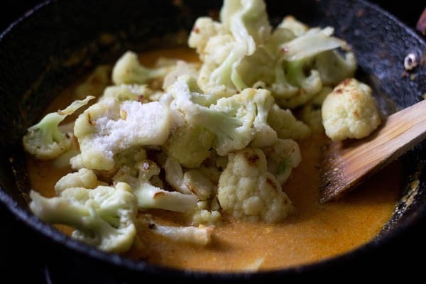 sautéed gobi florets and salt added to the pan. 