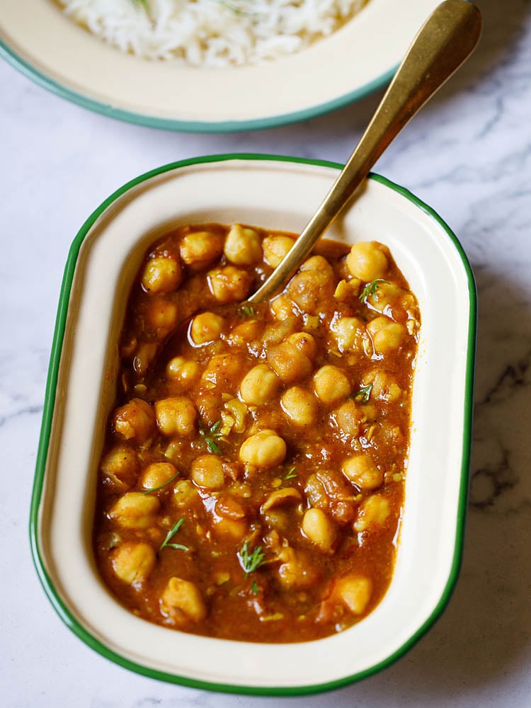 Instant Pot Chana Masala in a rectangle shaped bowl with a spoon in it