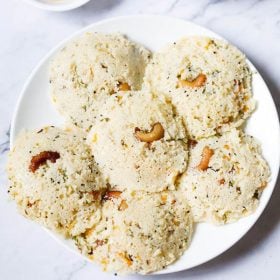 rava idli served on a white plate.