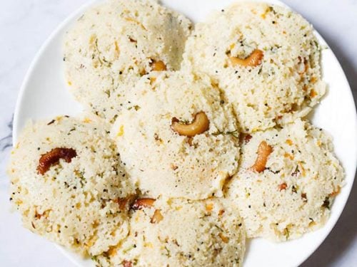 rava idli served on a white plate.