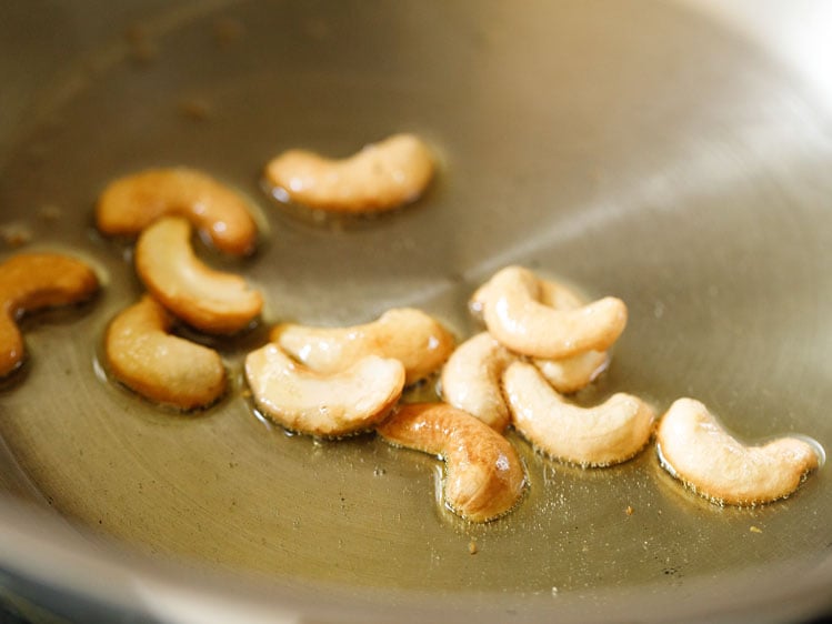 frying cashews in ghee in pan for making suji ki idli. 