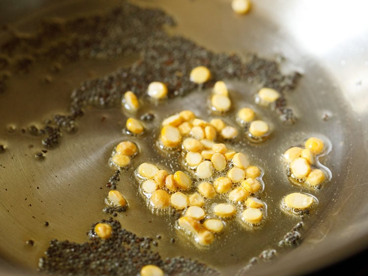 chana dal added to pan for making suji ki idli. 