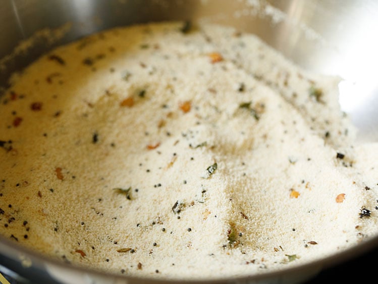 roasting rava in the pan for making suji ki idli. 