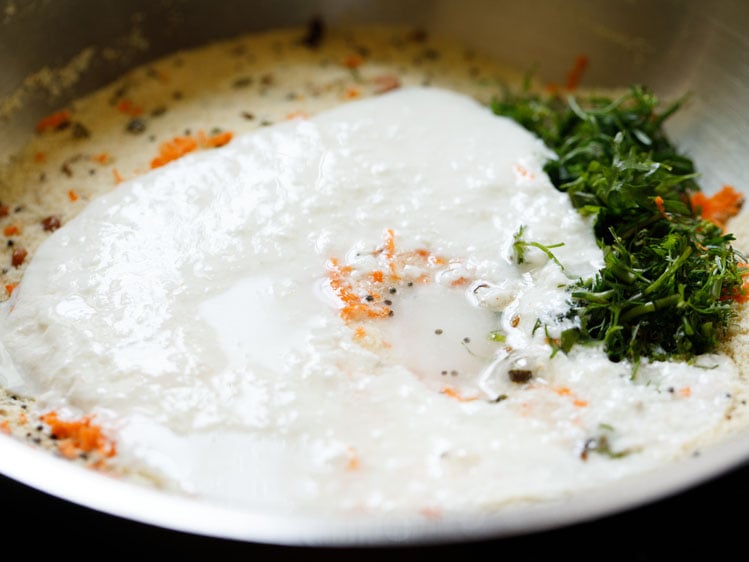 curd and water added to rava mixture for making suji ki idli. 