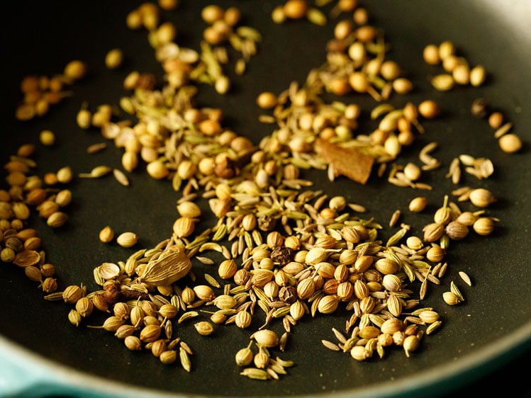 Indian spices in a skillet being roasted