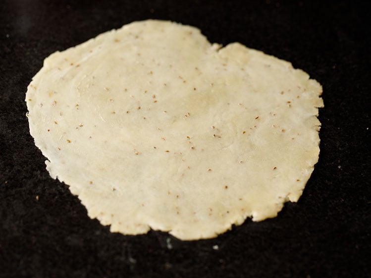 thin rolled dough on a black surface