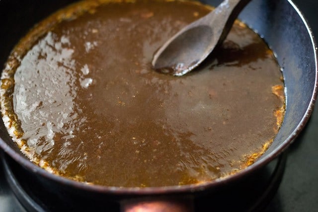 strained tamarind pulp added to the frying pan