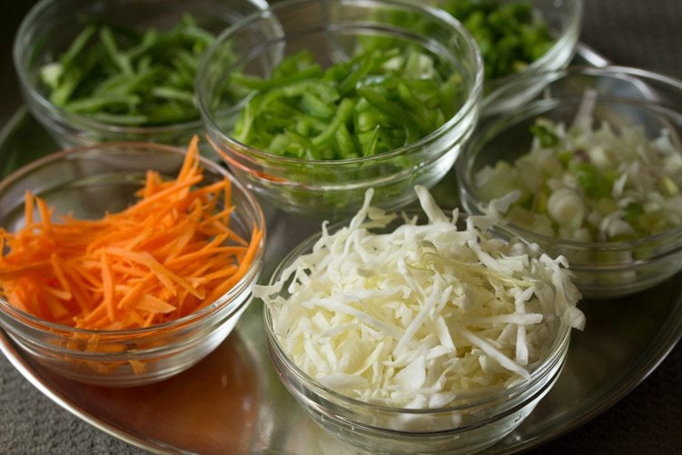 chopped and shredded veggies kept in separate glass bowls