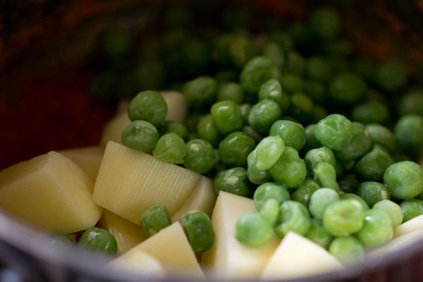 potatoes and peas added to pot for aloo matar recipe