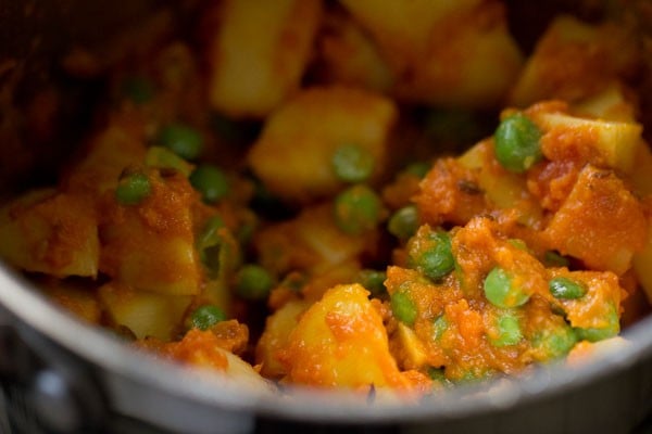 stir veggies into gravy for aloo matar recipe