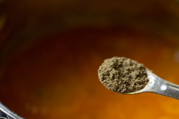 garam masala being added to gravy