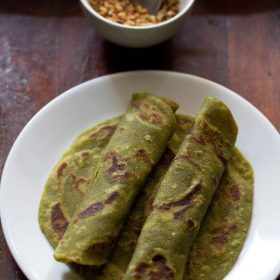 aloo palak paratha on a white plate.