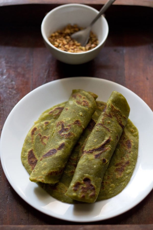 aloo palak paratha on a white plate.