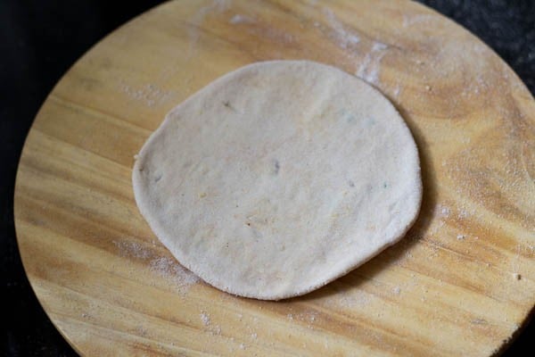 rolling dal paratha on a board