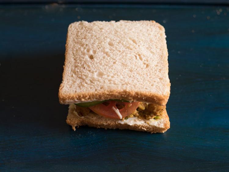 masala spread bread covered with another bread slice for making chana sandwich.