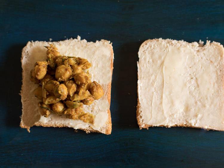 chana masala added on one buttered bread slice.
